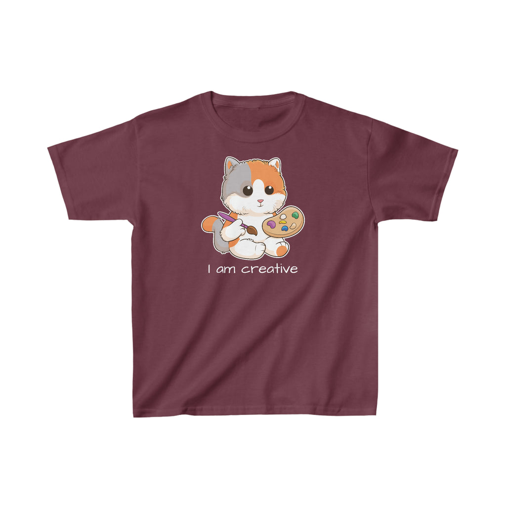 A short-sleeve maroon shirt with a picture of a cat that says I am creative.