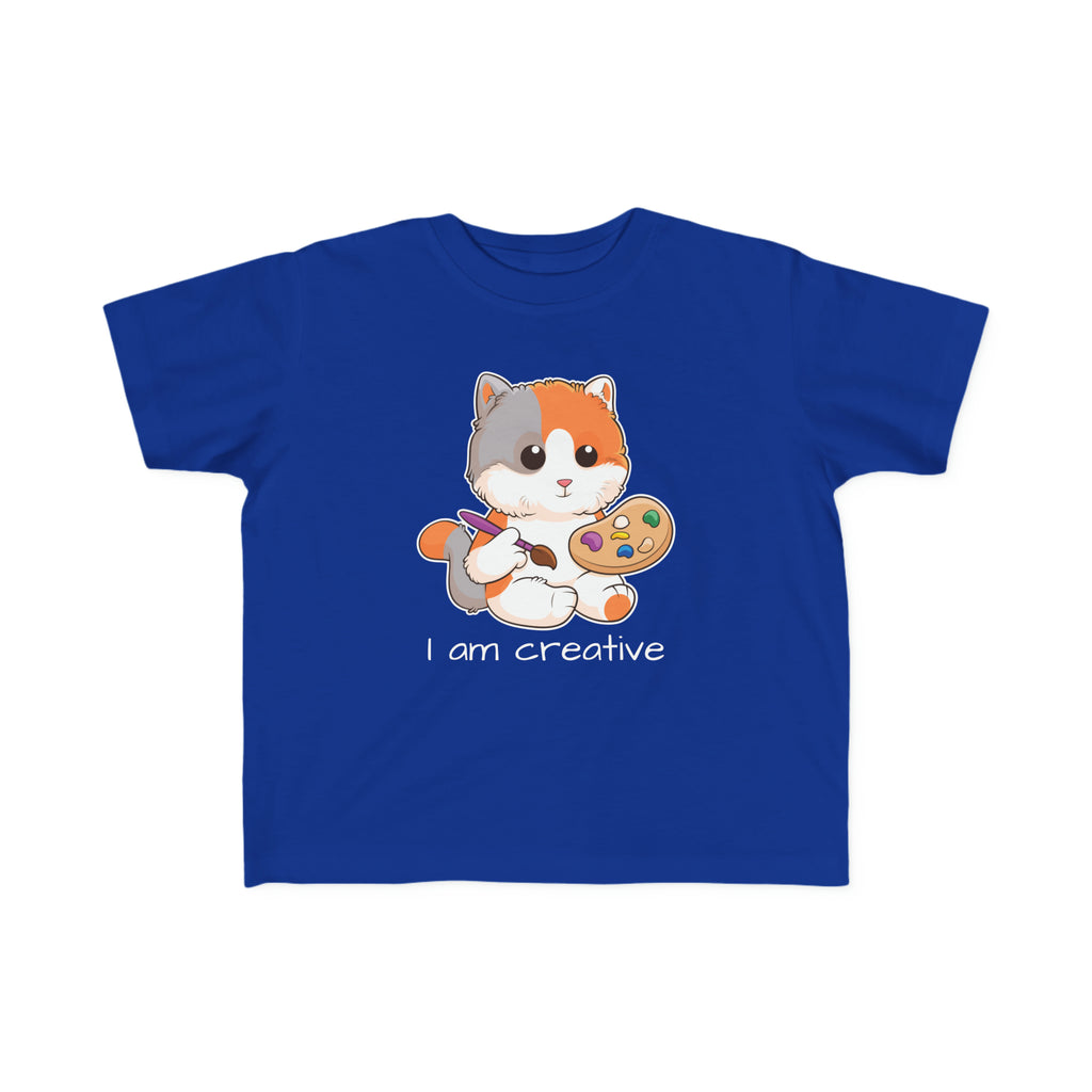 A short-sleeve royal blue shirt with a picture of a cat that says I am creative.