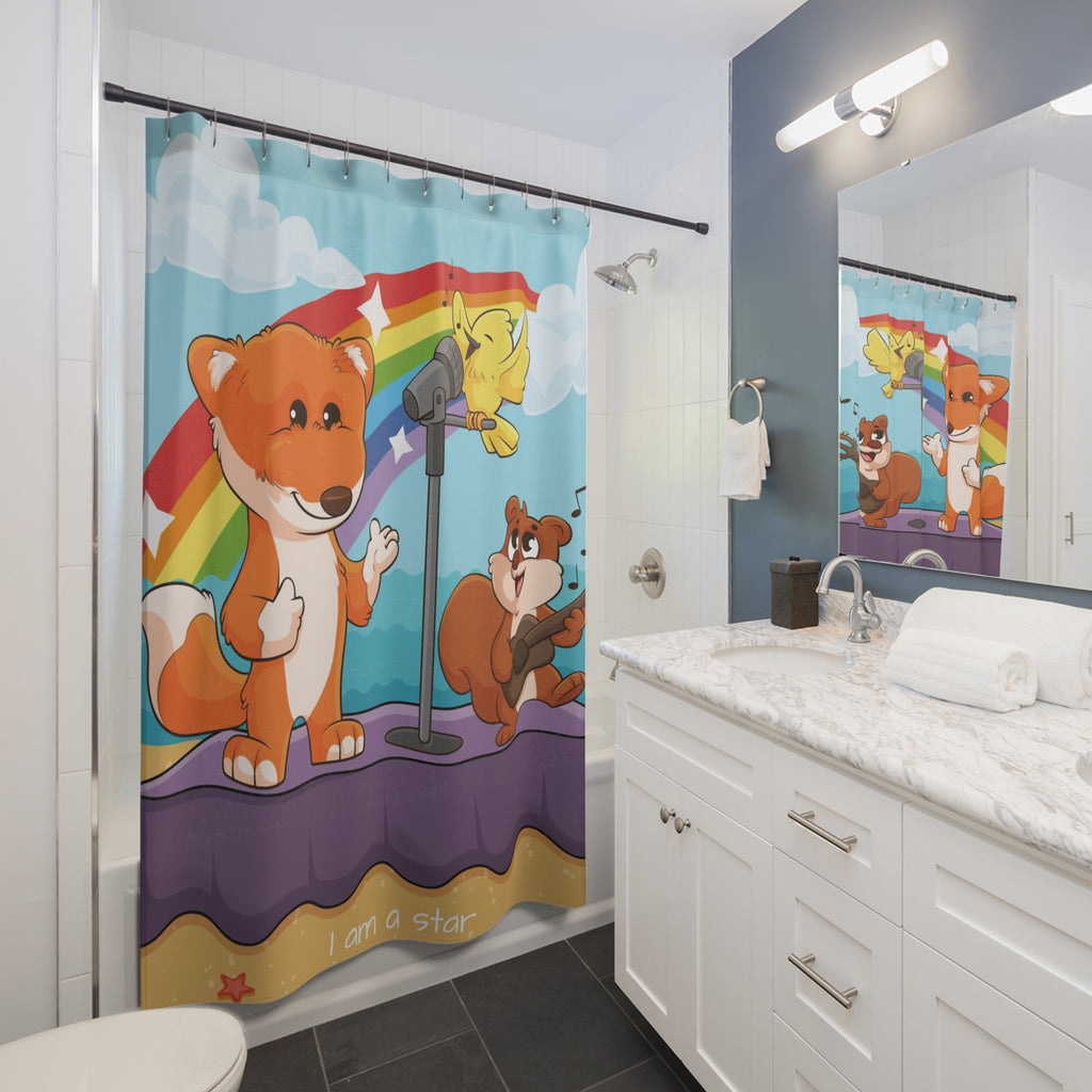 A shower curtain hanging from a rod in front of a built-in tub in a bathroom. The shower curtain has a scene of a fox singing with a bird and squirrel on a stage on the beach with a rainbow in the background and the phrase "I am a star" along the bottom.