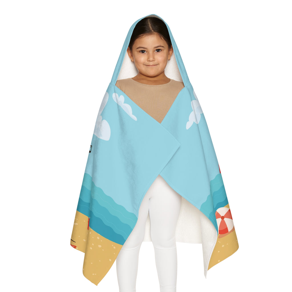 Front-view of a girl wearing a hooded towel and holding it closed around her. The towel has a scene of a fox singing with a bird and squirrel on a stage on the beach, a rainbow in the background, and the phrase "I am a star" along the bottom.