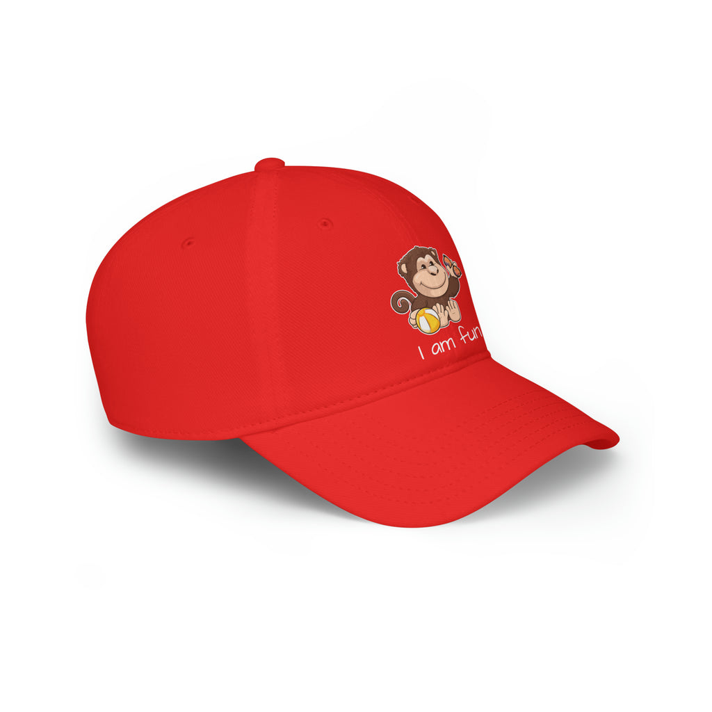 Side-view of a red baseball hat with a picture of a monkey that says I am fun.