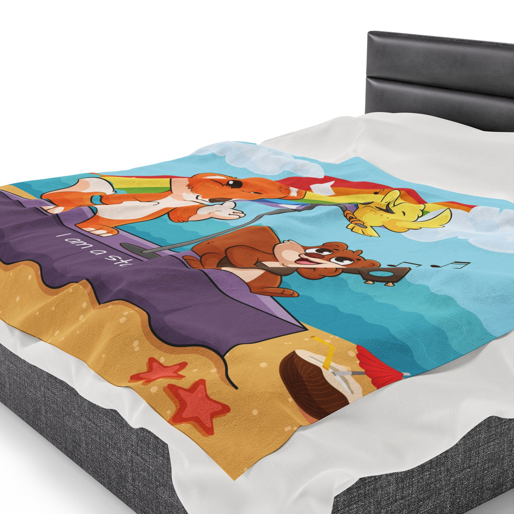 Side-view of a 60 by 80 inch blanket on a queen-sized bed. The blanket has a scene of a fox singing with a bird and squirrel on a stage on the beach, a rainbow in the background, and the phrase "I am a star" along the bottom.