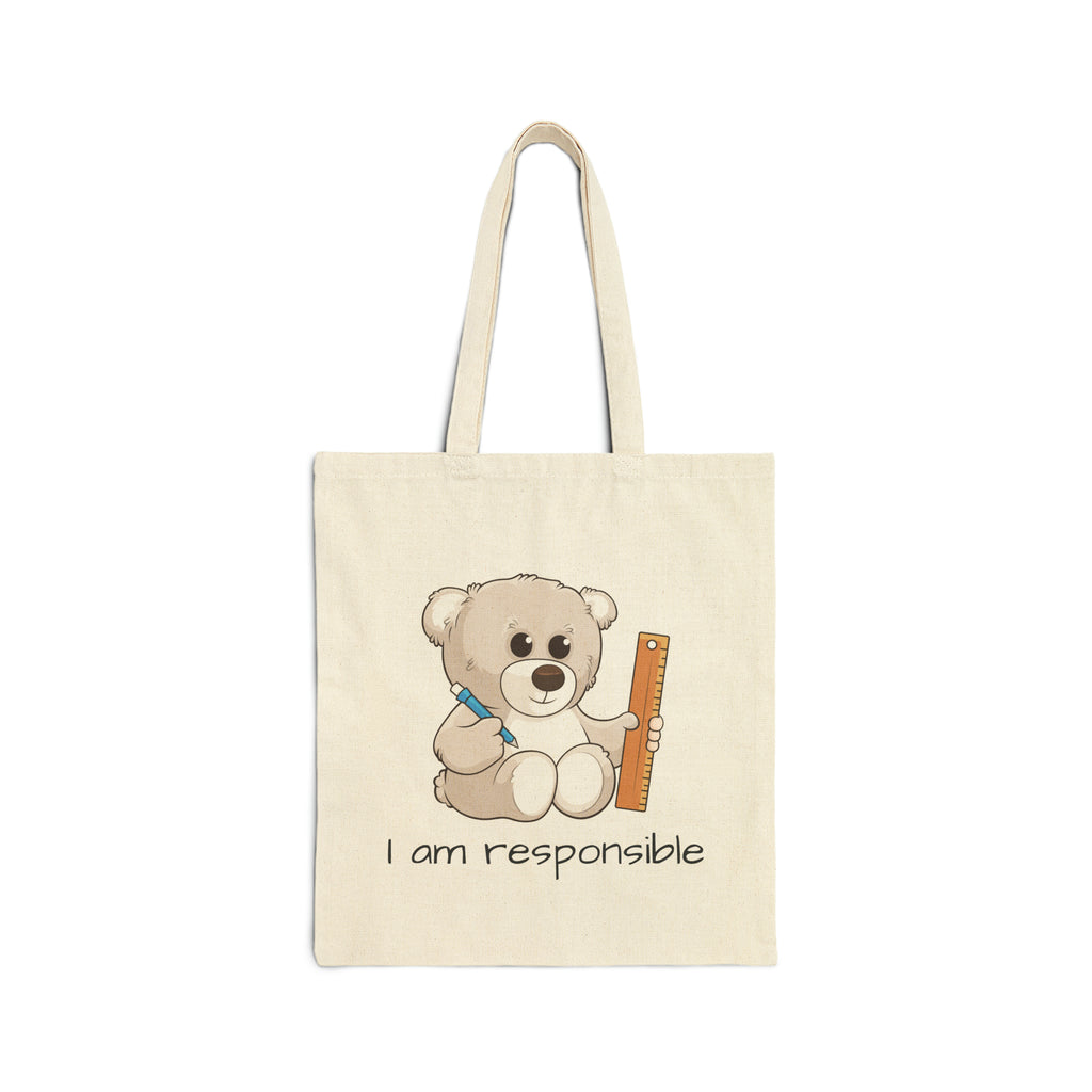 A natural tan tote bag with a picture of a bear that says I am responsible.