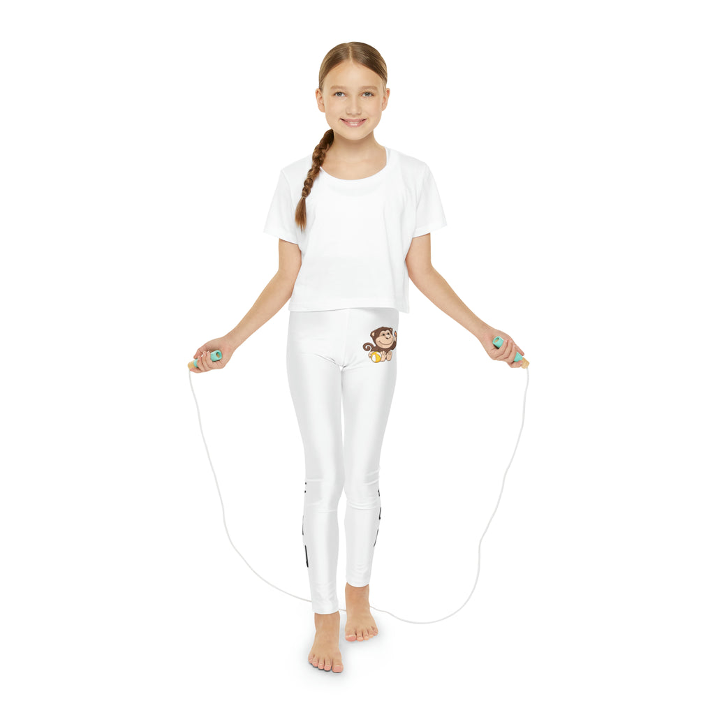 A girl using a jump rope while wearing white leggings with a picture of a monkey on the front left waist and the phrase "I am fun" read top to bottom on the side of each leg.