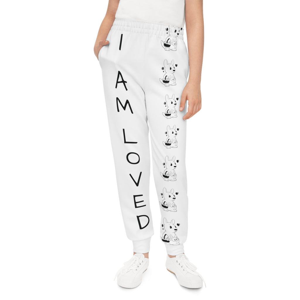 Front-view of a girl wearing white sweatpants with a line of black and white kangaroos down the front left leg and the phrase "I am loved" down the front right leg.