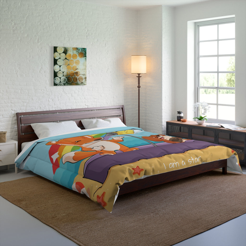 A 104 by 88 inch bed comforter with a scene of a fox singing with a bird and squirrel on a stage on the beach, a rainbow in the background, and the phrase "I am strong" along the bottom. The comforter covers a queen-sized bed.