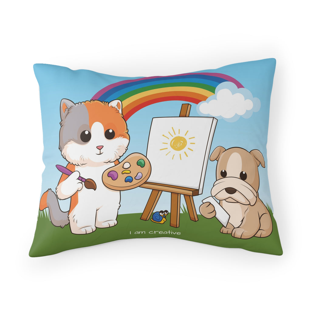 A pillowcase with a scene of a cat painting on a canvas next to a dog, a rainbow in the background, and the phrase "I am creative" along the bottom.