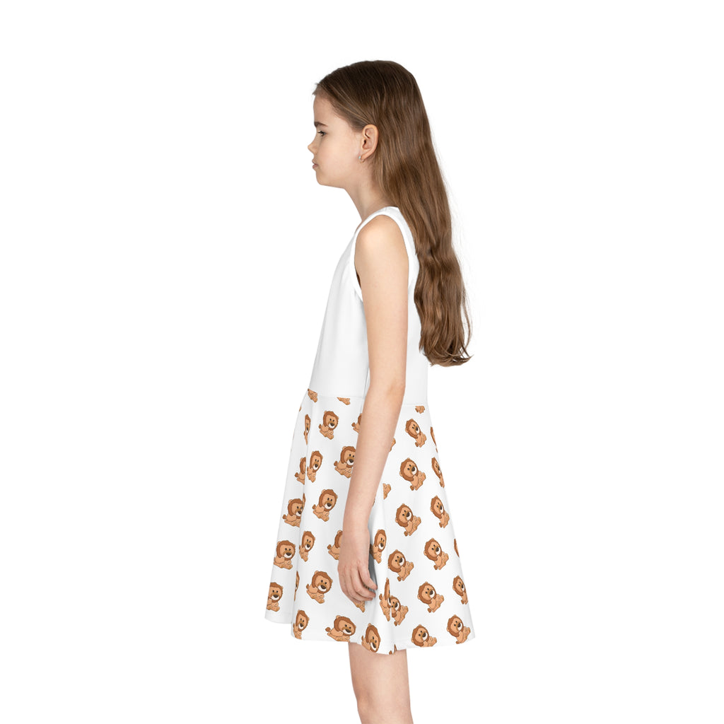 Left side-view of a girl wearing a sleeveless white dress with a white top and a repeating pattern of a lion on the skirt.